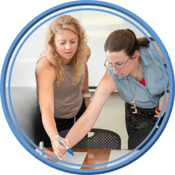 Independent Schools Leadership: Two teachers mark a paper on a table