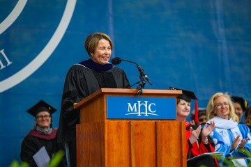 Governor Maura Healey speaking at the podium during Mount Holyoke’s Commencement Ceremony
