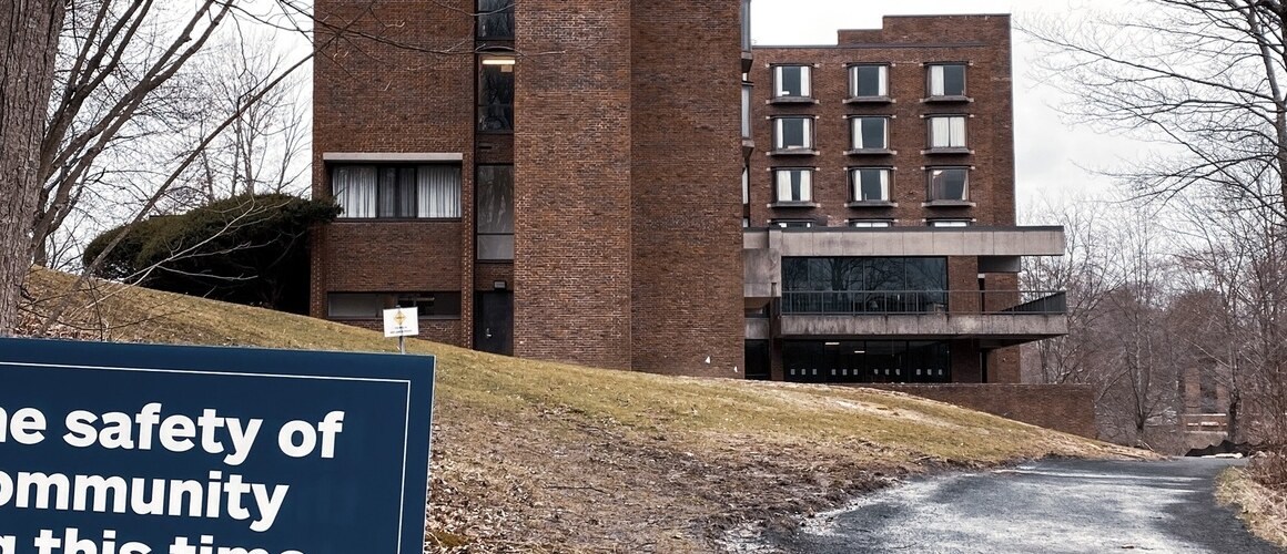 Sign of the times: Campus signs remind those who remain to practice physical distancing during the COVID-19 pandemic.