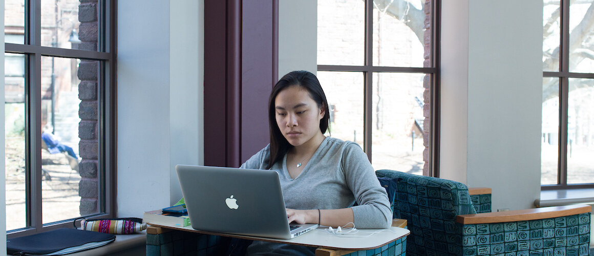 Student on a laptop in the library.