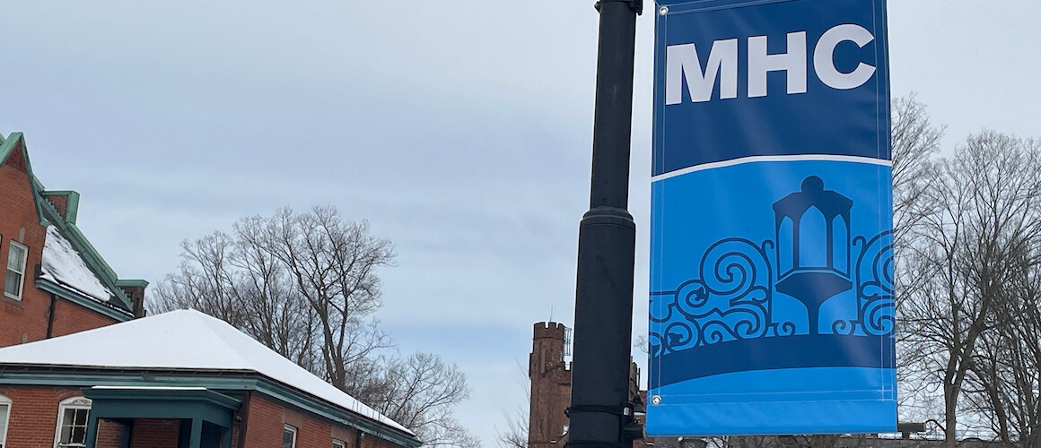 MHC campus banners with the gate on a cloudy winter's day