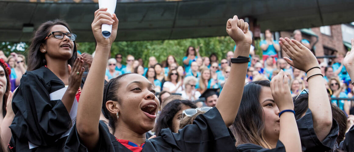 Students standing and cheering during convocation
