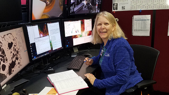Professor Darby Dyar at the x-ray microprobe instrument at beamline 13 IDE, Advanced Photon Source, Argonne National Laboratory, where she will study pristine lunar material. Photo credit: Molly McCanta