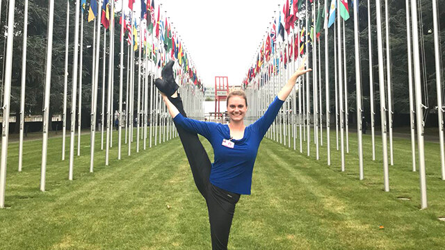 Davan O’Donnell ’19 poses amidst the flags of the members of the United Nations, outside the UN headquarters in Geneva. O’Donnell and Javeria Kella ’19 (not pictured) are earning master’s degrees in the Swiss city while they’re still undergraduates.