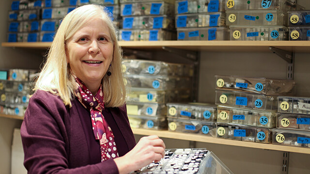 Astronomy professor Darby Dyar poses with a tray of samples in her lab.