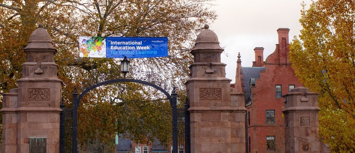 Mount Holyoke College's Gates draped with a banner celebrating International Education Week