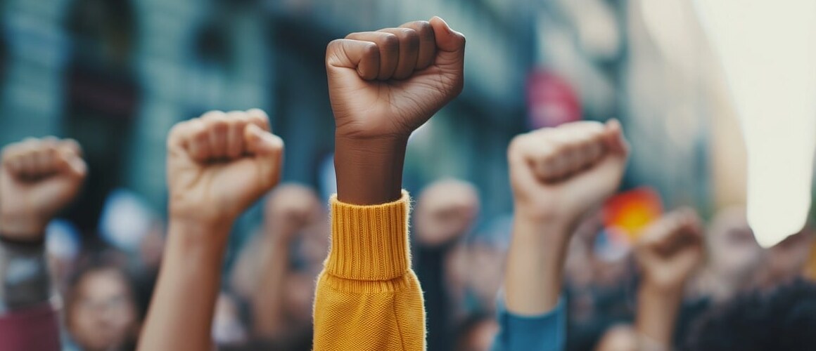 Fisted hands are raised in the air.