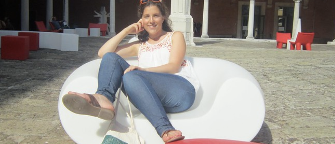 Kathryn Higgins '12 lounging in a courtyard in Italy