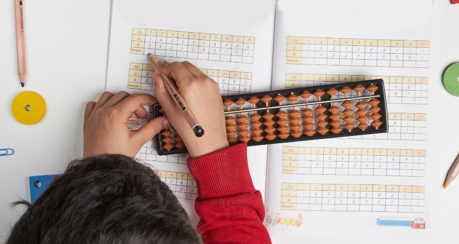 Student doing math with a bead board.