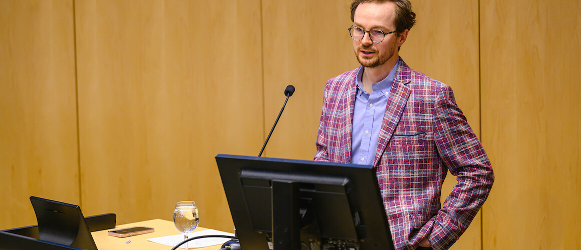 Adam Hilton presenting at “What to Expect in the 2024 US Elections,” held in October 2024.