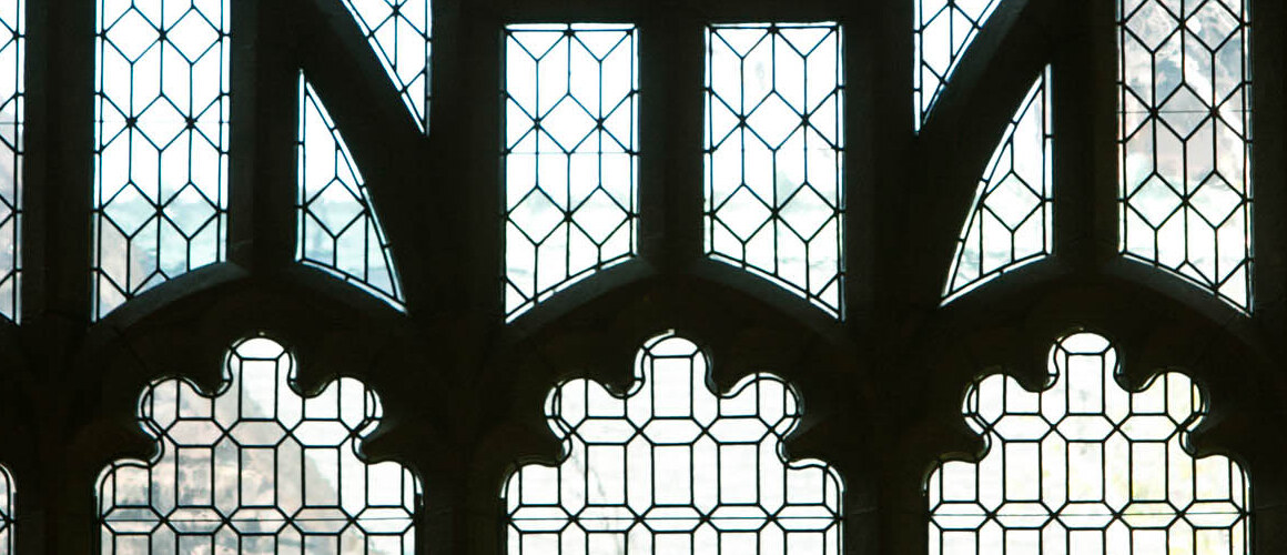 A window in the Mount Holyoke College library that displays seals of five colleges