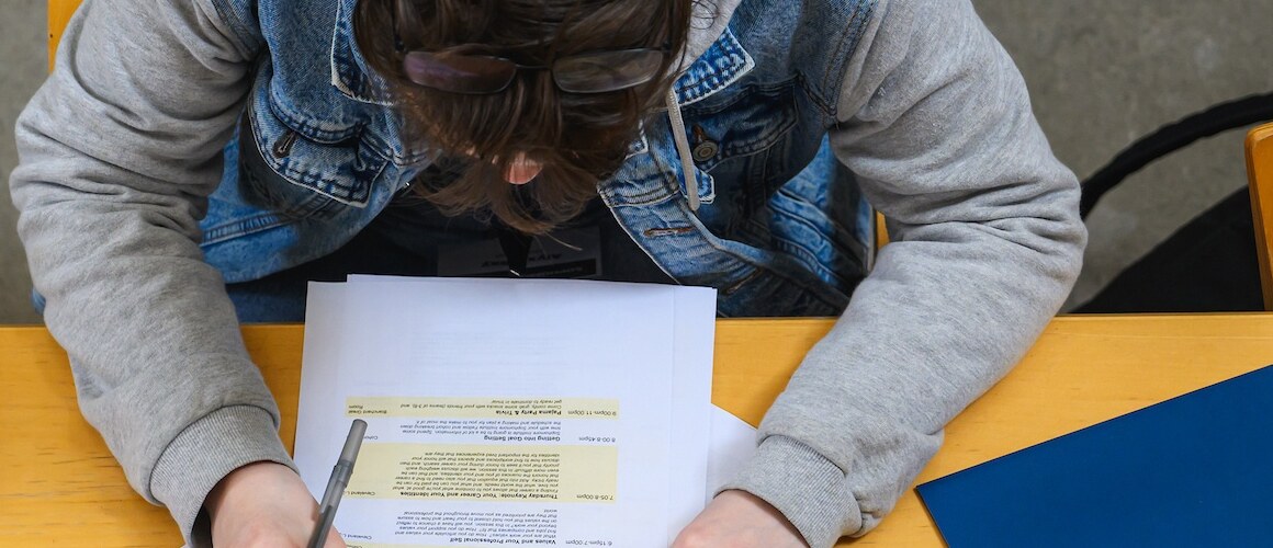 Overhead view of a student looking at paperwork at the Sophomore Institute at Mount Holyoke College.