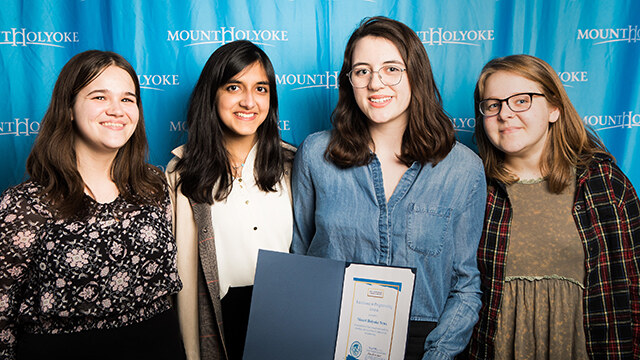 Mount Holyoke News staff pose with their prize for excellence in programming (from left): Zoe Zeligman ’19, Risha Dewan ’18, Lindsey McGinnis ’18 and Emily Blomquist ’18.