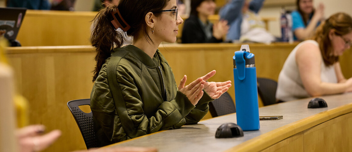 Student clapping in a lecture hall.