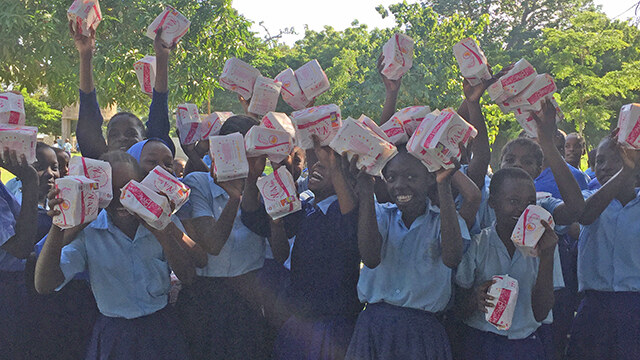 Sexual and reproductive health education and support is critical around the world. Here rural youths celebrate receiving needed supplies.