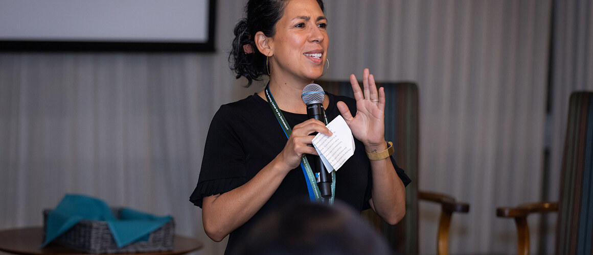 Olivia Aguilar speaking in front of an audience, photo by Jo Chattman.