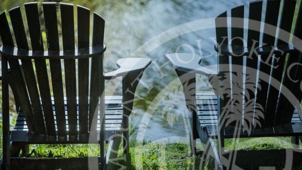 Adirondack chairs at MHC with MHC logo watermarked over it.