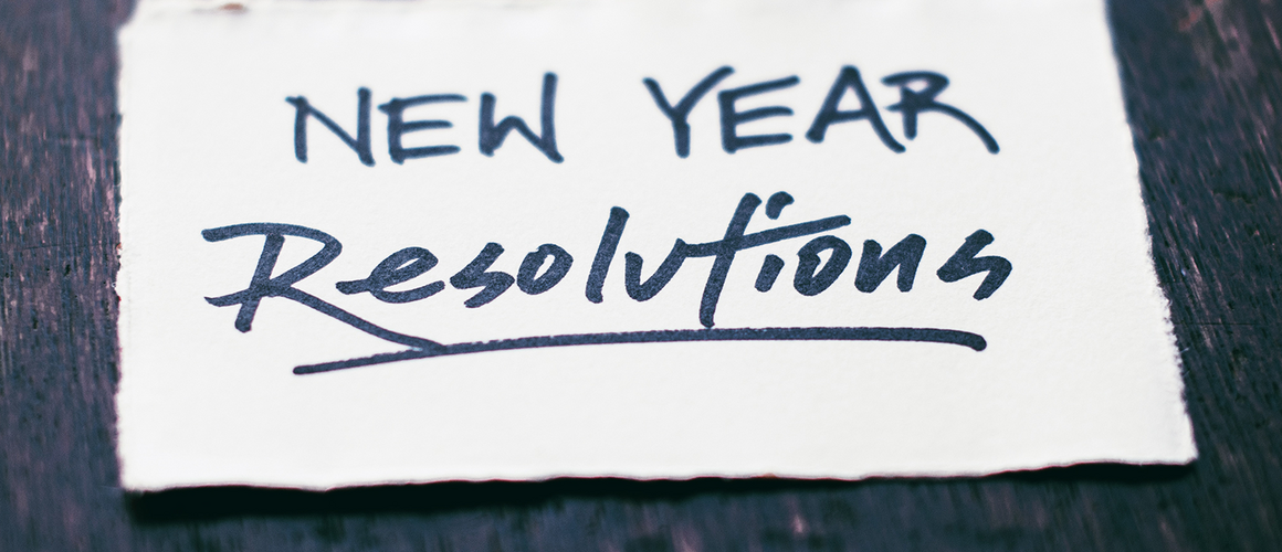 A piece of paper that says “New Year Resolutions.” Photo by Tim Mossholder on Unsplash.
