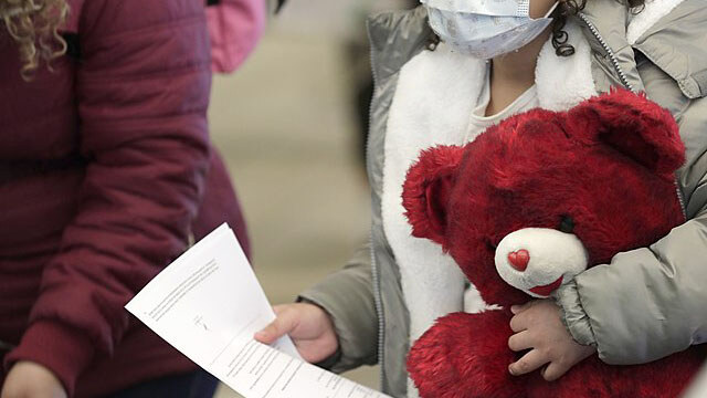 U.S. Customs and Border Protection officers and agents process a small group of asylum-seekers who have active applications under the Migrant Protection Protocols at the Paso del Norte Port of Entry in El Paso, Texas, February 26, 2021. Under the Migrant Protection Protocols established in January, 2019, migrants seeking asylum were required to remain in Mexico while their applications were processed.