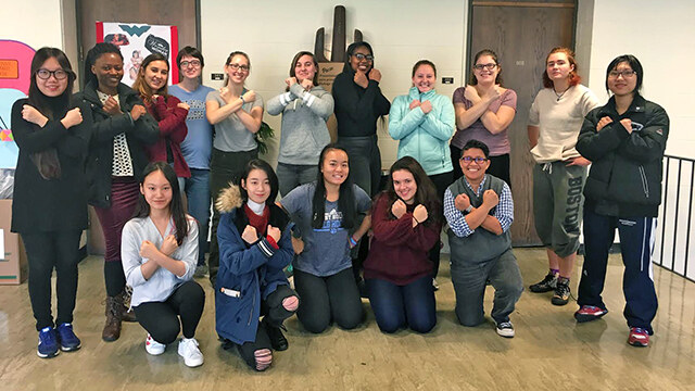 The students of Jennifer Matos’ first-year seminar, Wonder Woman: The Original Social Justice Warrior, strike the heroine’s iconic pose at the end of the semester with their professor (first row, far right).