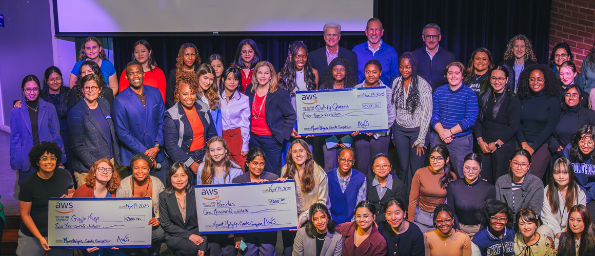 Participating Mount Holyoke faculty and students pose together on stage with AWS awards.
