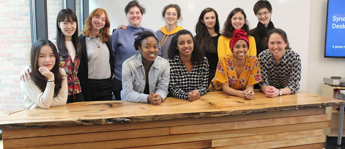 The reception desk designed and built by students (pictured left with Professor Naomi Darling, front right) in the design-build class held in the Fimbel Lab.