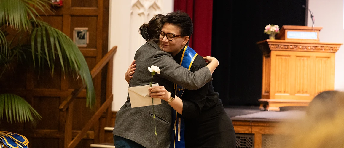 Student and mentor hug during the Stoling Ceremony at Mount Holyoke College in 2026